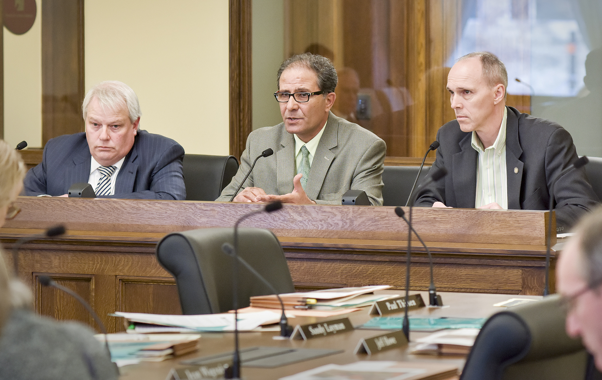 Dan Dorman, left, executive director of the Greater Minnesota Partnership, and Abraham Algadi, center, executive director of the Worthington Regional Economic Development Corporation, testify before the House Job Growth and Energy Affordability Policy and Finance Committee in support of a bill sponsored by Rep. Rod Hamilton, right, that would establish a refundable workforce housing tax credit. Photo by Andrew VonBank